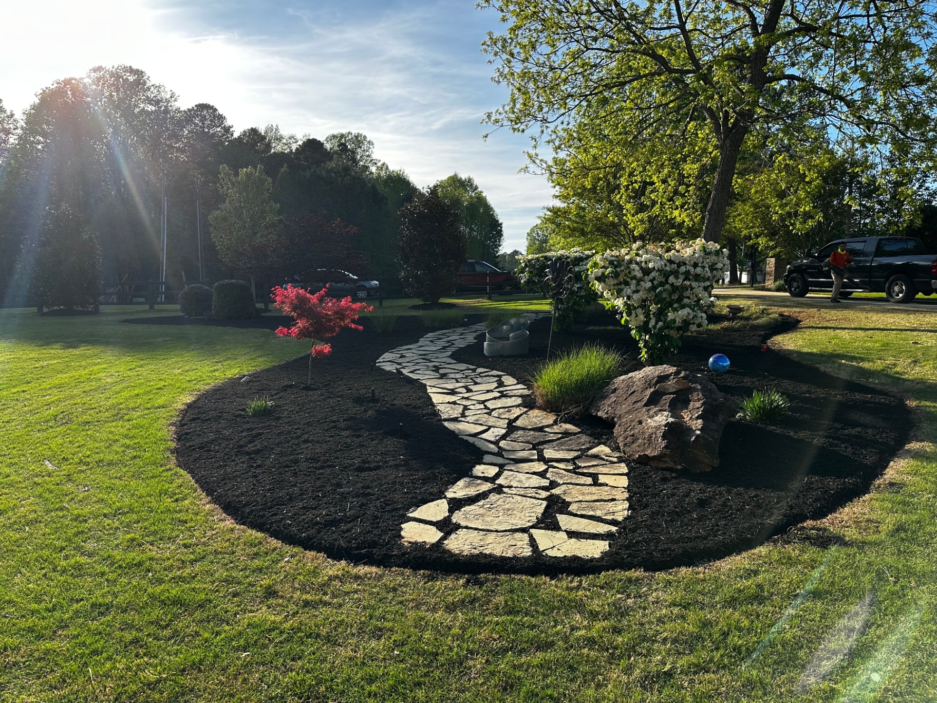 Curved flagstone walkway with fresh mulch