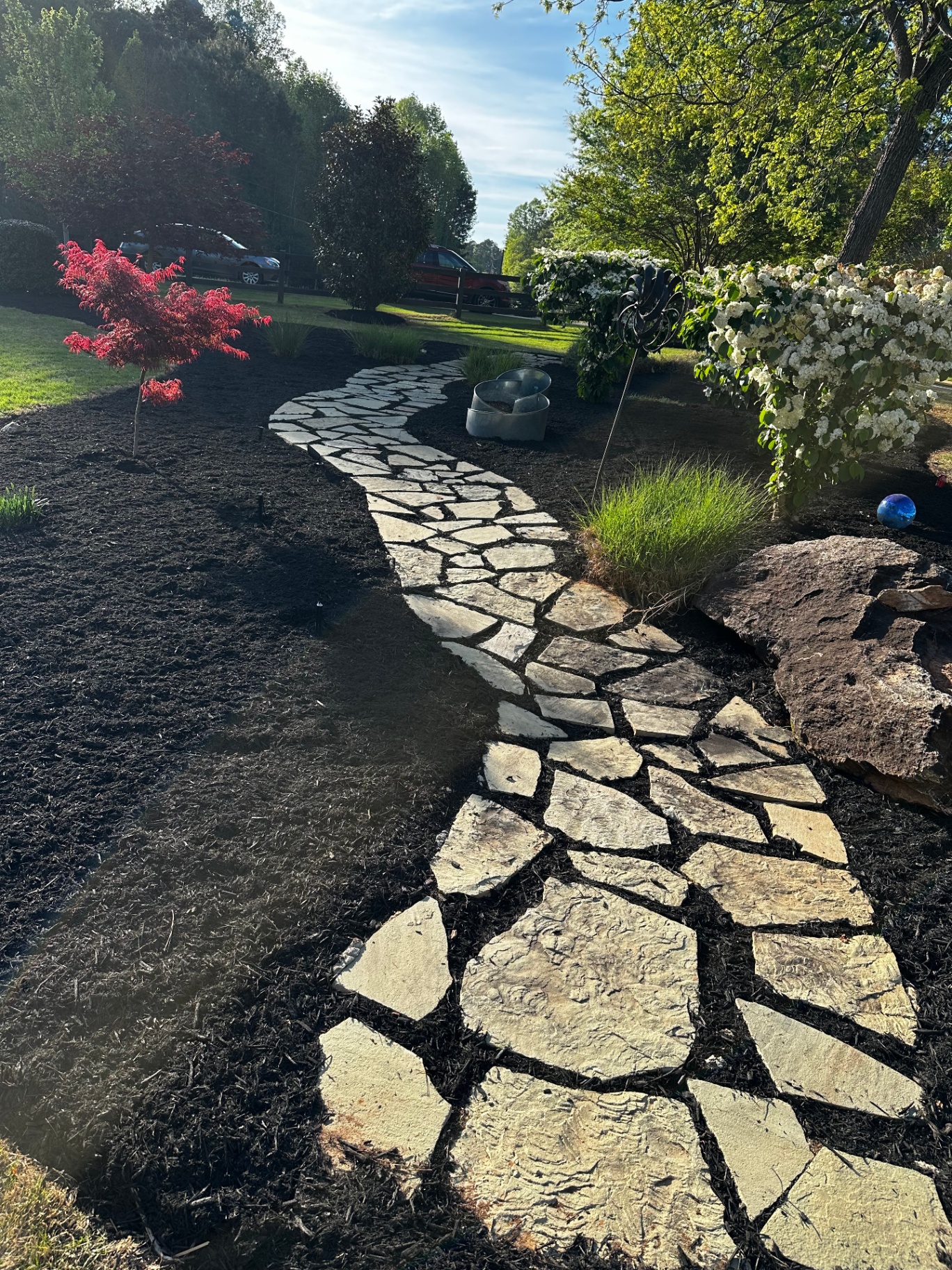 Custom flagstone pathway through mulch beds