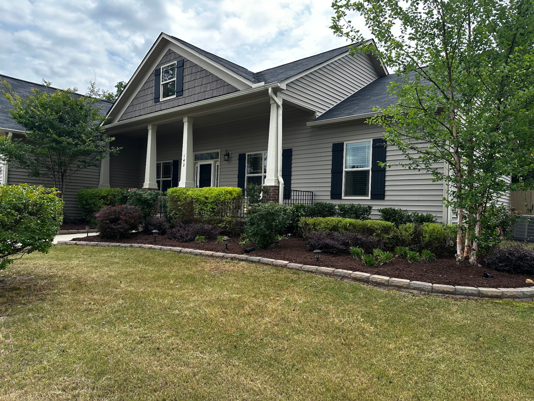 Manicured front yard with paver-edged beds