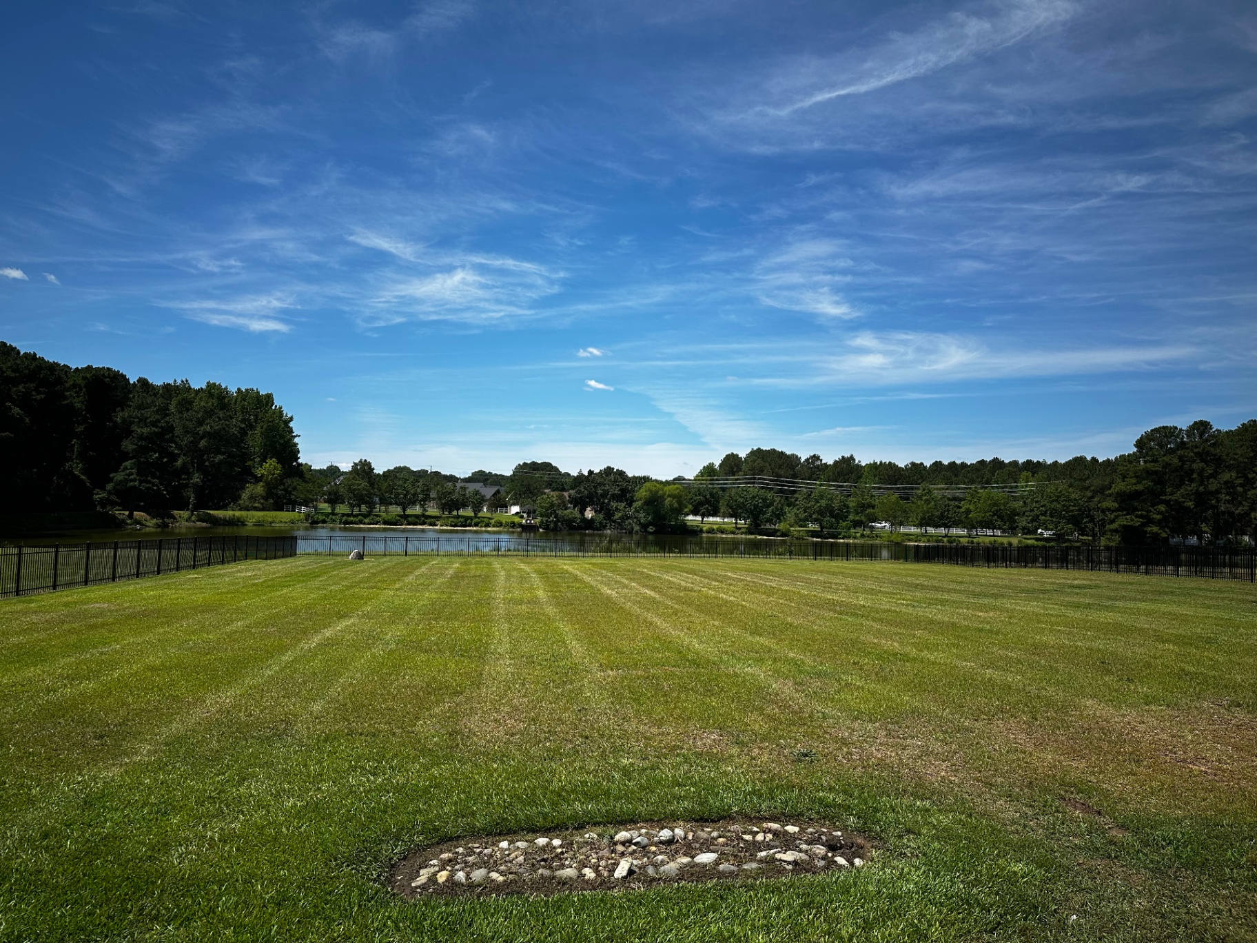 Striped lawn overlooking a pond